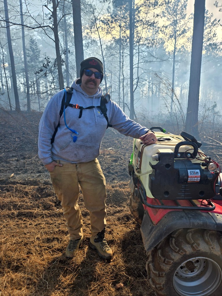Three accompaniments of an outdoor fire. The pieces of wood appear part-cylinder in cross-section and are scored in lines ...
